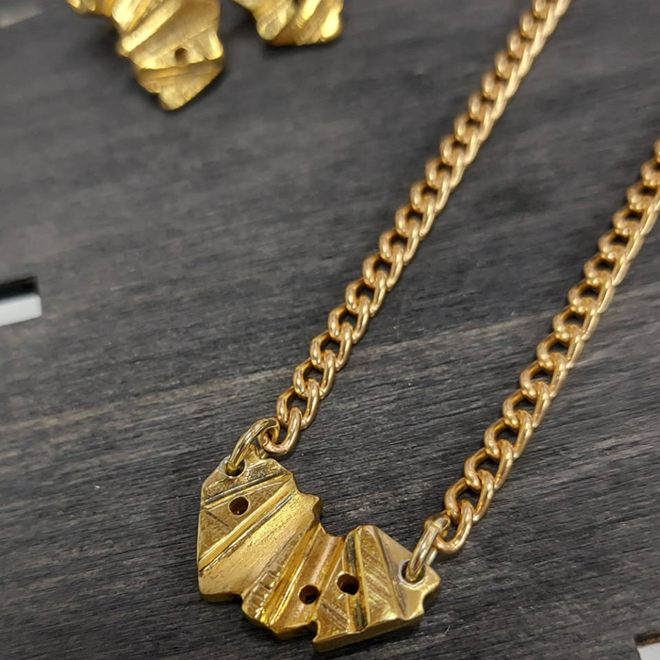 18ct gold plated pendant on board